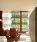 Double room at vigilius mountain resort with cozy armchairs and a view outside.
